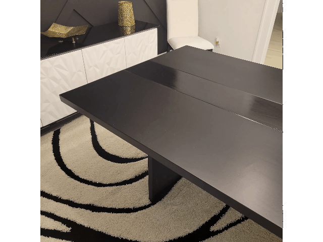 Custom modern dining table showing raw white oak construction versus finished two-tone black high-end furniture.